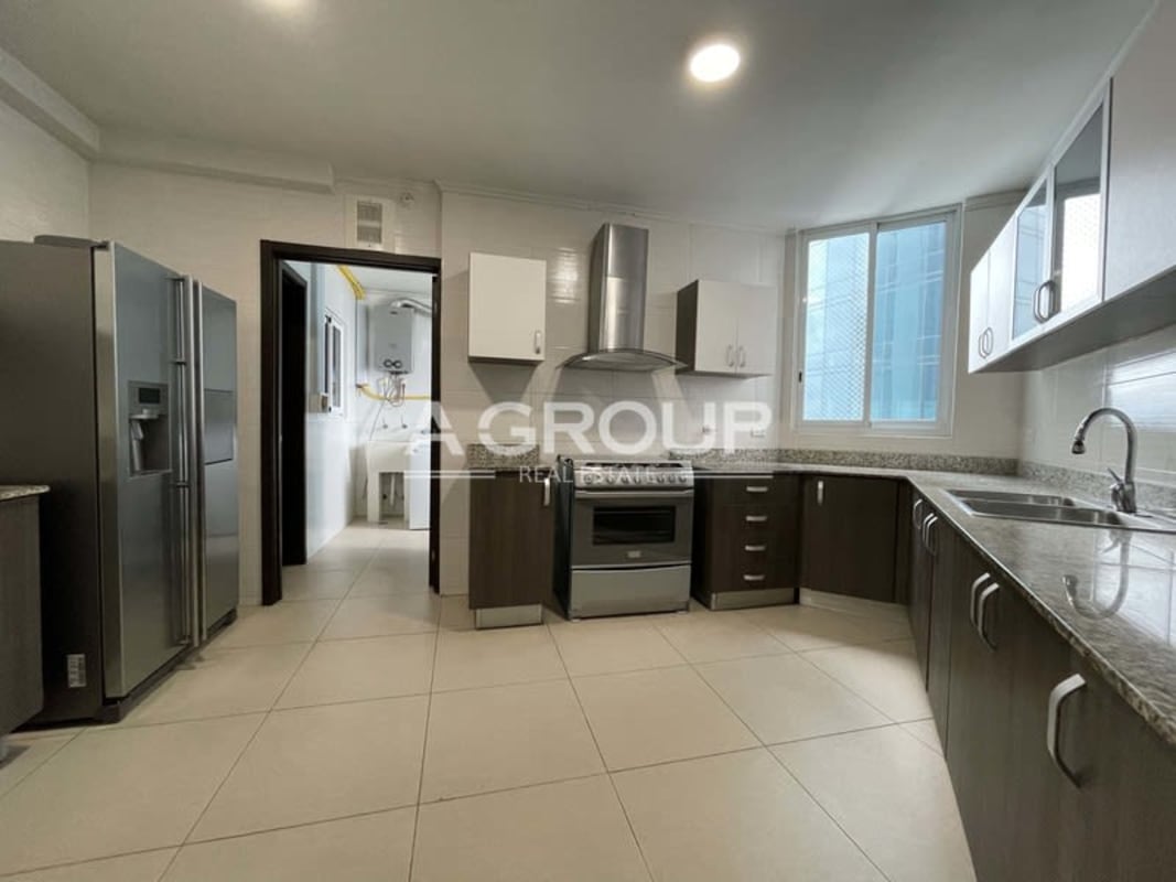 Granite kitchen with stainless appliances and modern cabinetry in Costa del Este Panama City