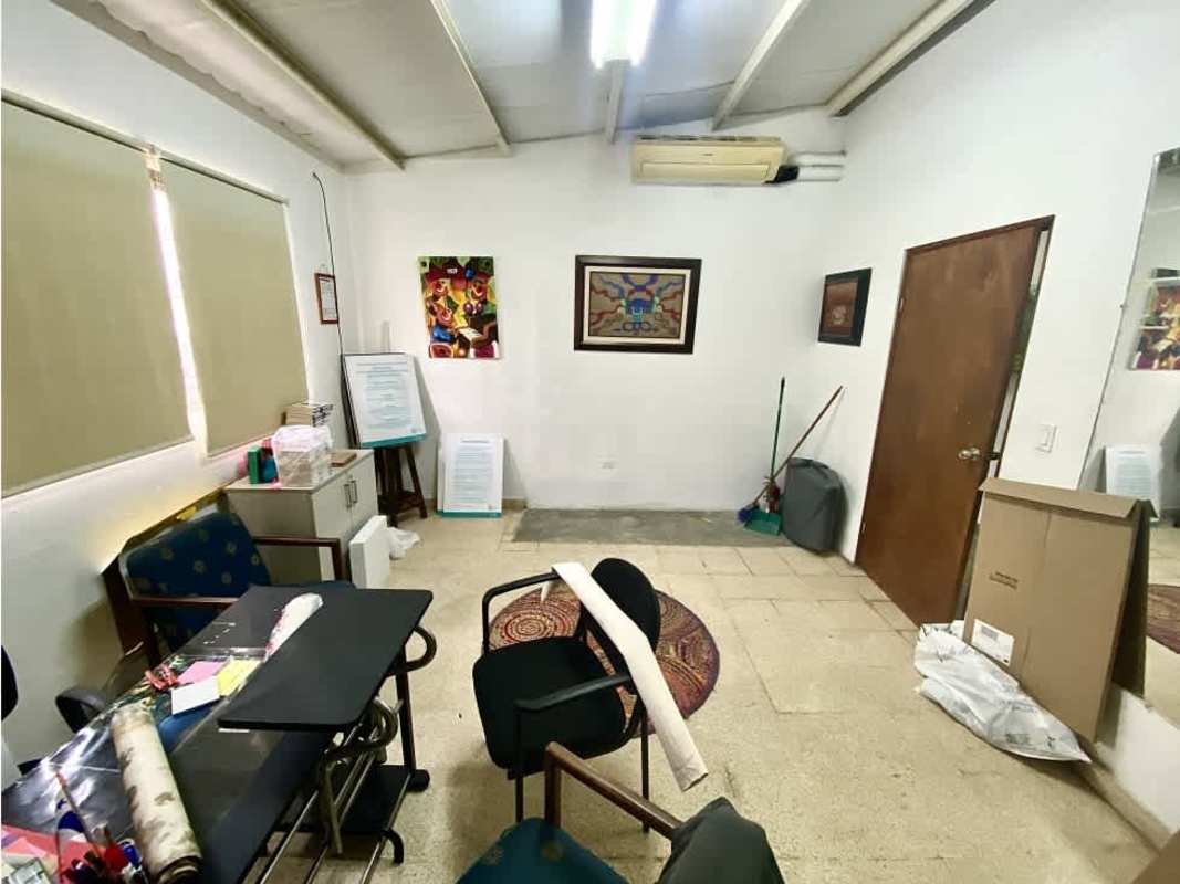 Open interior with high ceilings, exposed beams and art installations in San Francisco commercial property