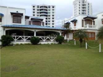 Mediterranean beachfront home porch, blue trim, lush tropical garden view Playa Blanca Panama