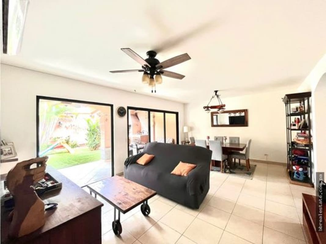 Open concept living and dining area with sliding doors to garden in PH Versalles Costa Sur Panama