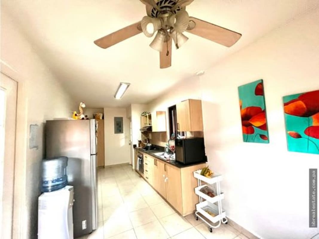 Kitchen with granite counters, wooden cabinets, stainless appliances PH Versalles Costa Sur Panama