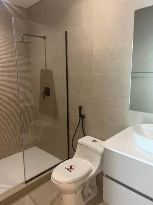 Modern bathroom with glass enclosed shower and vanity at PH Nogal Costa del Este