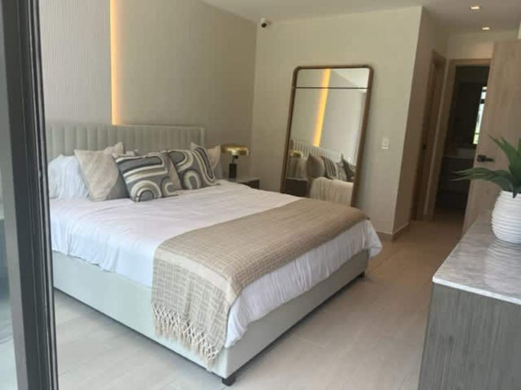Main bedroom with large window, modern design, city view at PH Nogal Costa del Este Panama