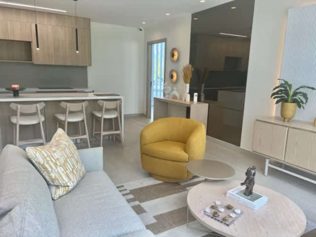 Elegant open plan living dining space with large windows and view balcony at PH Nogal Panama