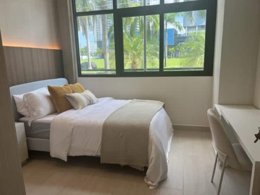 Contemporary guest bedroom with built-in desk, window, wood finishes PH Nogal Panama