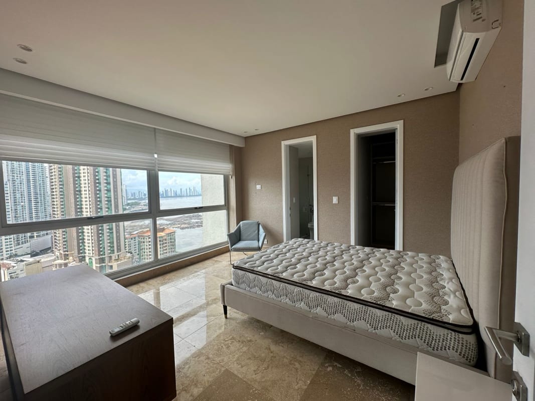 Open concept living area with inset lighting and full wall windows overlooking Pacific Ocean at Q Tower Panama City