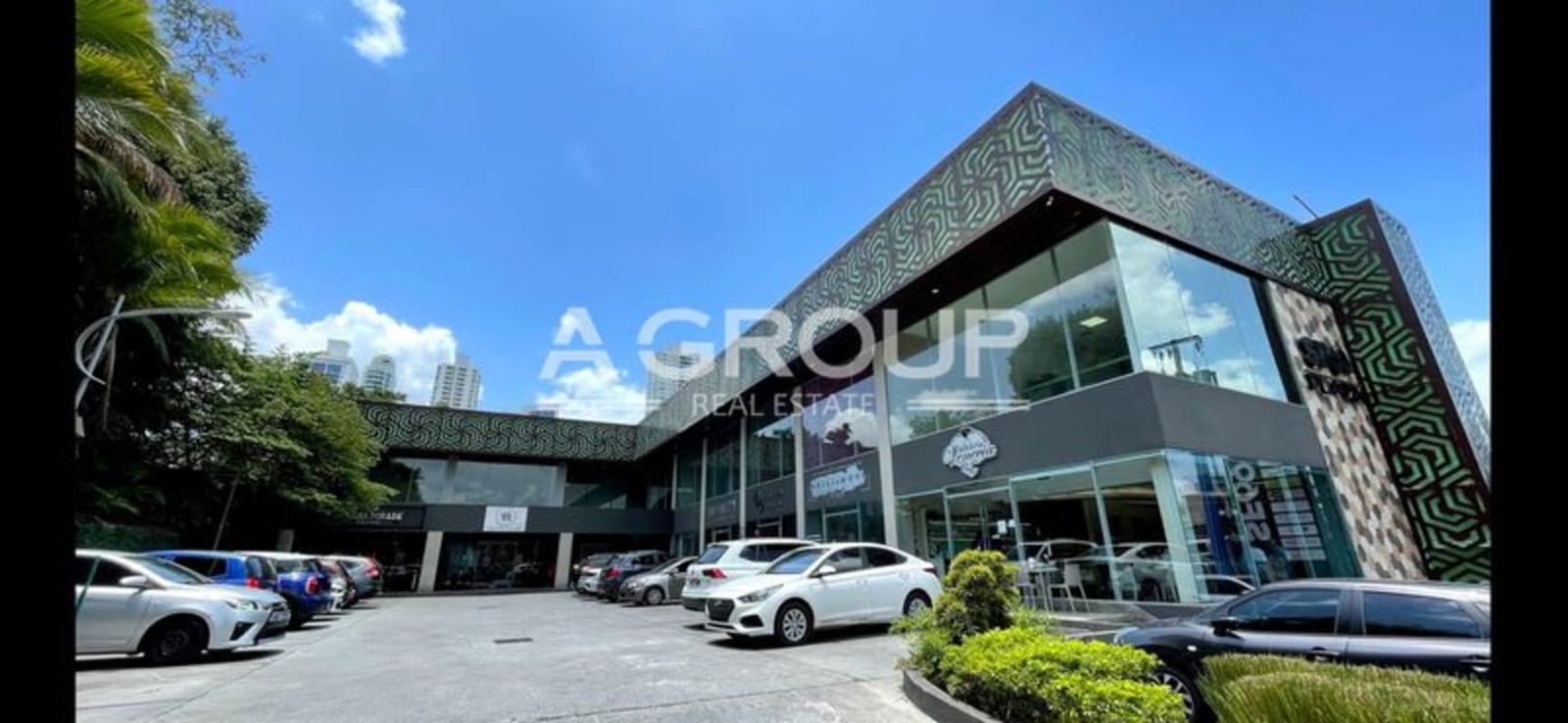 Modern two-story shopping plaza with glass facades and parking Plaza SF69 San Francisco Panama