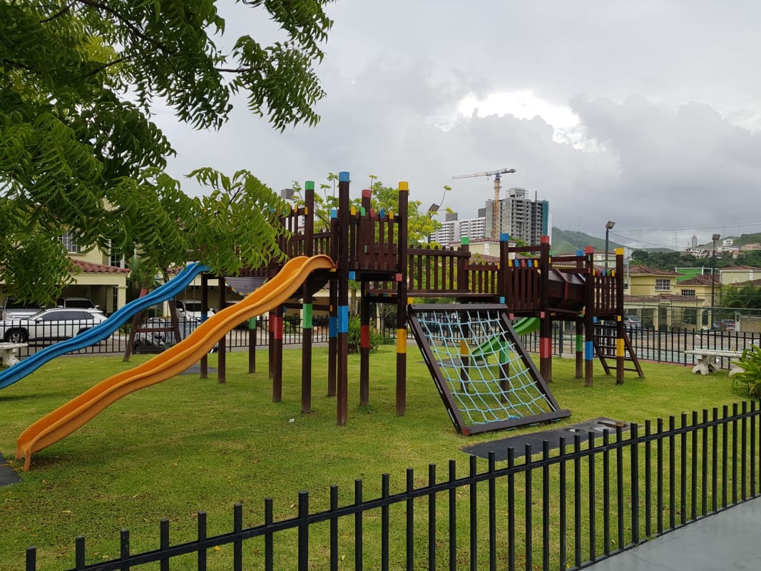 Mediterranean-style pool area with shaded social lounge and green gardens Crystal Springs Condado del Rey