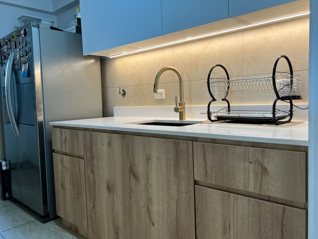 Kitchen granite countertop with adjacent laundry zone in Condado del Rey Panama apartment