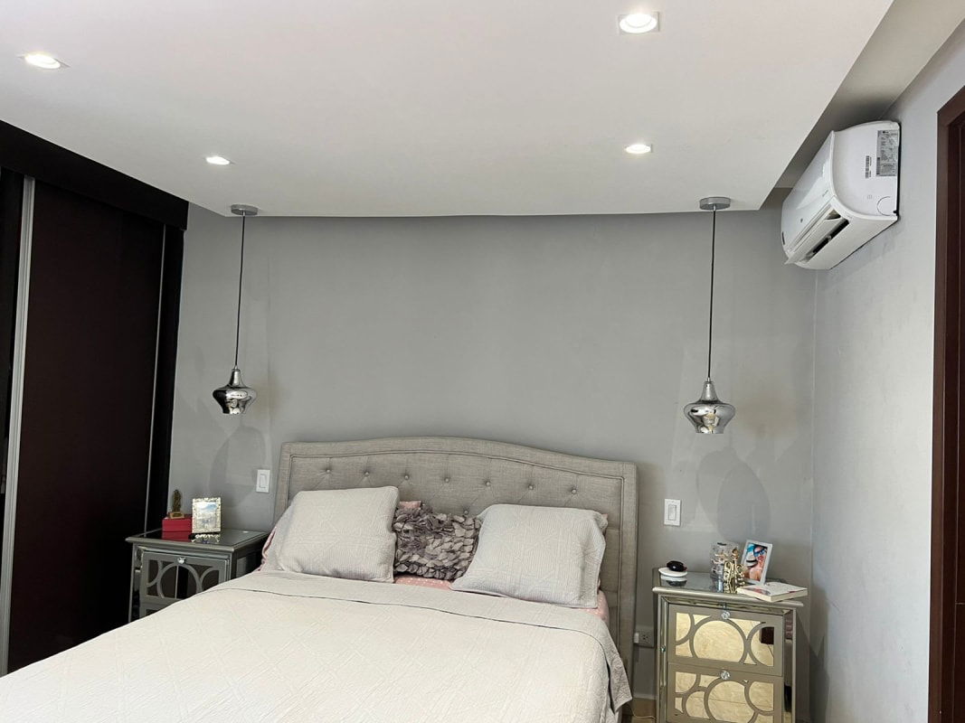 Main bedroom with closet and large window in apartment at Condado del Rey Panama