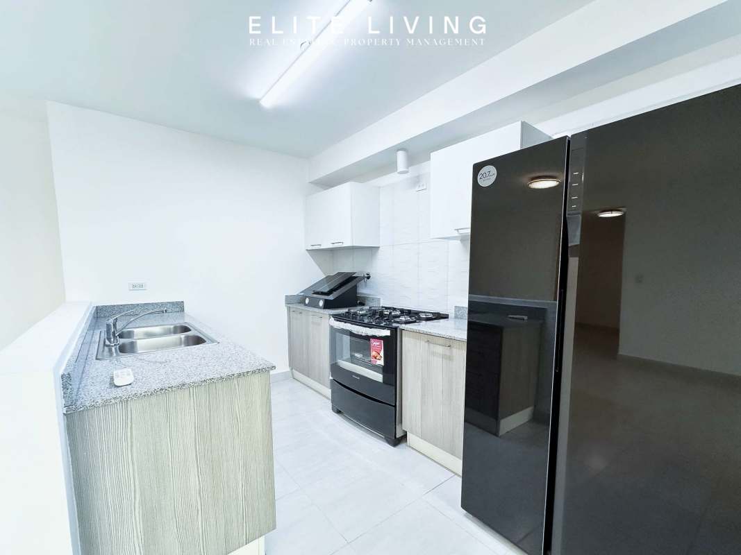 Modern bathroom with glass shower, accent tiles and vanity at Metropolitan Park Panama