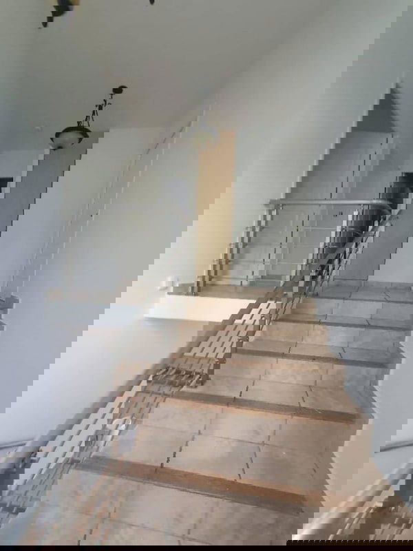 Bright stair landing and hallway white walls tile floor PH Everest