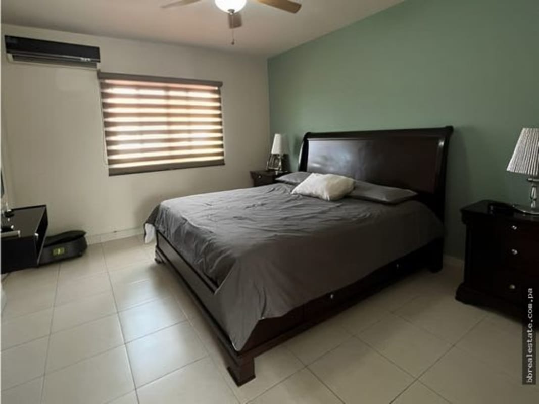 Master bedroom with balcony access, large windows and tile floors in Las Acacias Panama