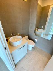 Modern bedroom with large window, scenic greenery, flat screen TV, and AC in PH Solea Punta Barco