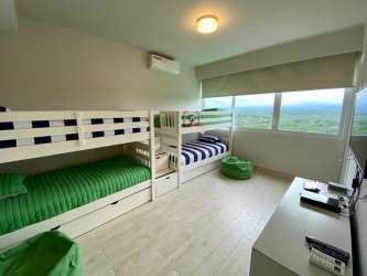 Contemporary fully furnished bedroom with ocean view window PH Solea Punta Barco Panama