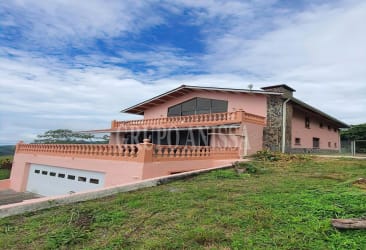 Dining room with large sliding doors and fan in mountain villa Panama