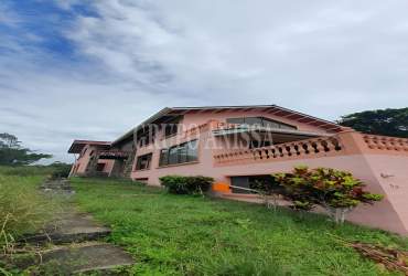 Living room with vaulted ceilings, tile flooring and fireplace in mountain house Altos del María Panama