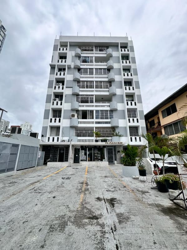 Small beige tile bathroom with pedestal sink, mirror, frosted window PH PlazaMar San Francisco Panama