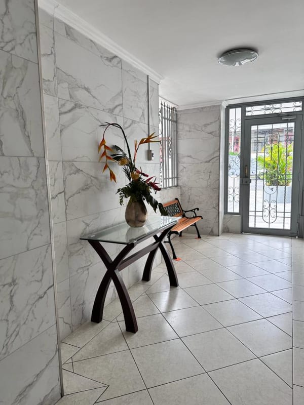 Lobby with marble tiles, glass doors, bench, reception in PH PlazaMar San Francisco Panama
