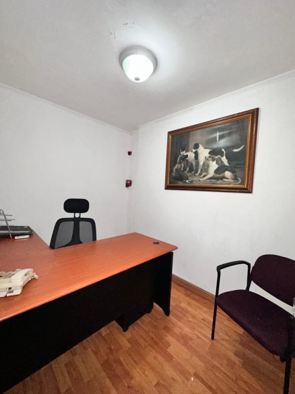 Minimalist small office with desk, black chair, computer setup near doorway in PH PlazaMar San Francisco Panama