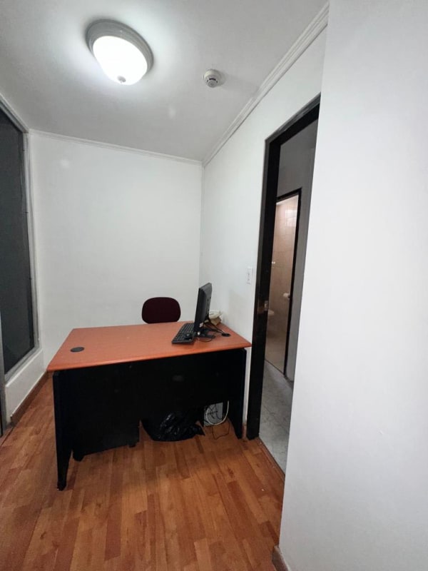 Minimalist private office with desk, chair, window, white walls in PH PlazaMar San Francisco Panama