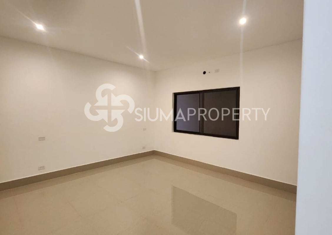 Modern empty bedroom with black framed window and glossy tile floor Las Acacias Panama house