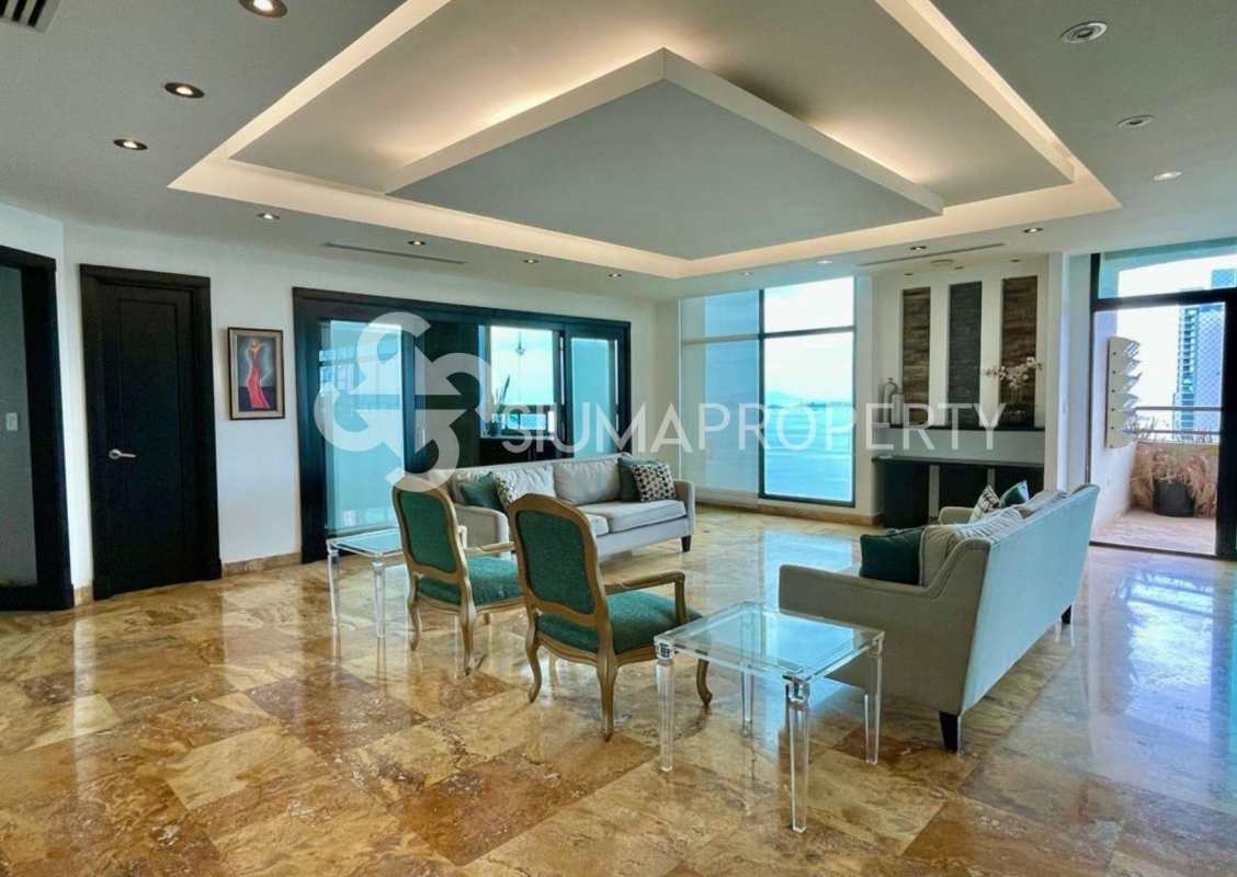 Luxurious living area with marble floors, floor-to-ceiling windows, ocean and city view in PH Ocean Park Panama