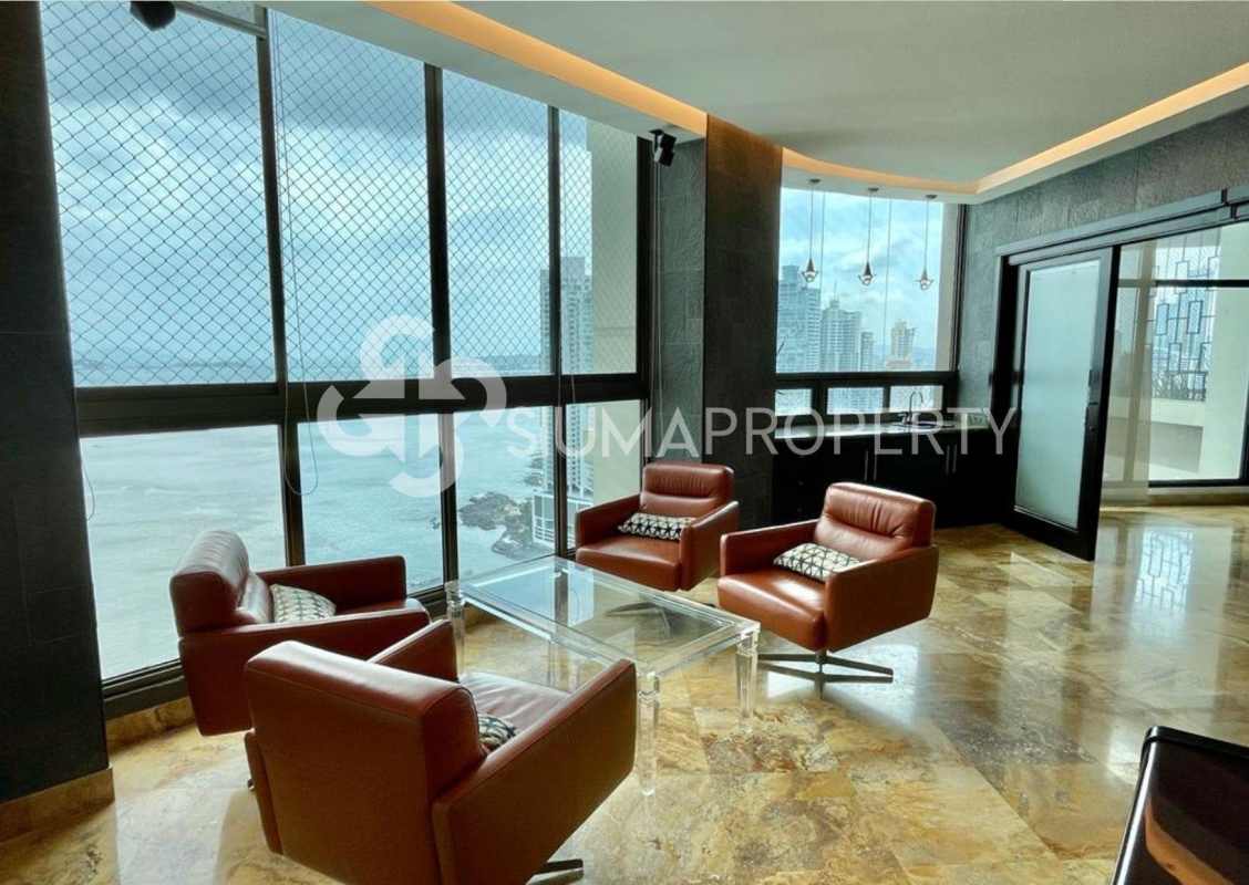 Modern lounge area with large windows, marble floors, bayfront views in PH Ocean Park Panama City