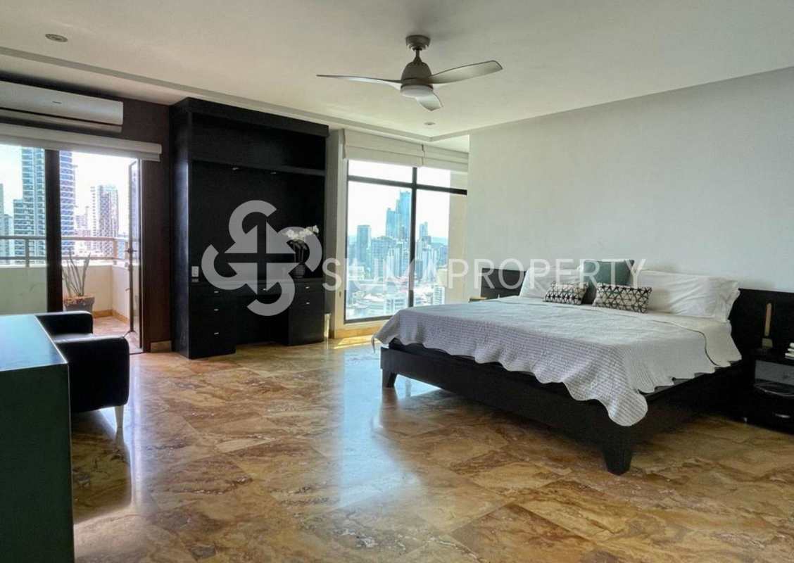 Contemporary bedroom with city skyline view, large windows, built-in storage in Ocean Park Punta Pacifica Panama