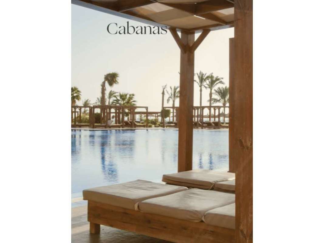 Outdoor pool, beach lounge, cabanas and landscaped resort community at The Palms Ocean Reef Islands Panama