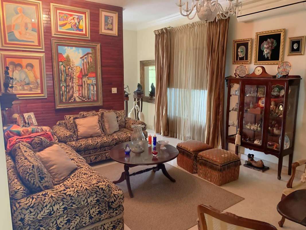 Traditional living area glass doors armchairs arch La Alameda Panama house