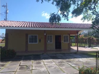 Single story ranch-style country beach house with covered porch and garden yard in Playa Gorgona Panama