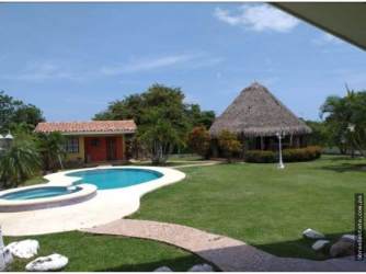 Covered outdoor terrace with view of private pool and garden Playa Gorgona Panama