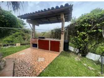 Rustic outdoor kitchen and BBQ grilling area beside patio in Playa Gorgona Panama