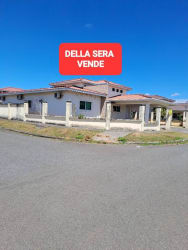 Exterior view of new corner house with fenced yard and covered porch in Coquito Hill David Panama
