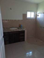 Bathroom with walk-in shower and granite countertop in new house Coquito Hill David Panama