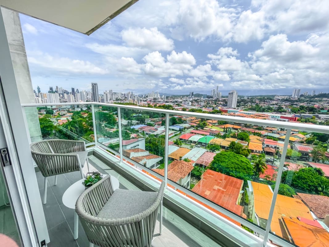 Modern entertainment room in PH Altamira penthouse with panoramic skyline views and lounge area