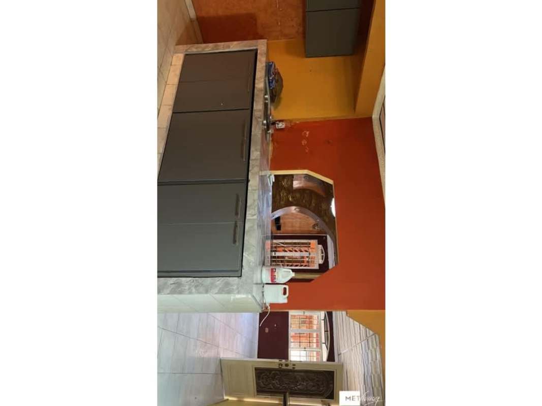 Kitchen with marble countertop, pass-through window, colorful walls, grey cabinetry in Altos de Plaza Tocumen Panama