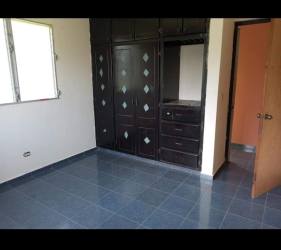 Bedroom with built-in wardrobe, blue tiled floor and window in Natá Coclé house for sale Panama