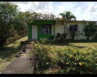 Exterior of single-family house with garden, secure fence, and front porch in Natá Coclé Panama