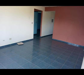 Open living and dining room with ceramic tile floors and bright natural light in Natá Coclé house