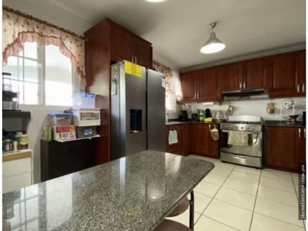 Spacious kitchen with wood cabinets, granite counters, stainless appliances in Brisas del Golf Panama