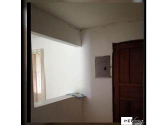 Entrance hallway with wooden door and white walls Rio Grande Penonomé Panama