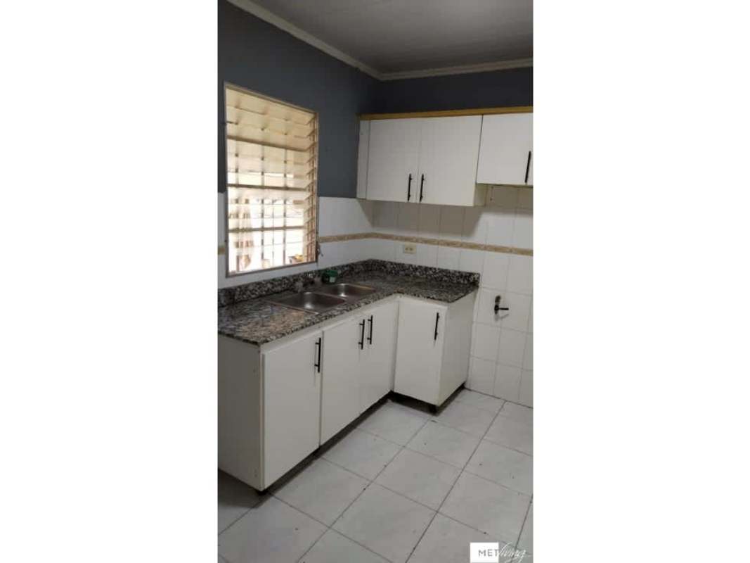 Kitchen with granite countertops, white cabinetry, tile backsplash in Dorasol Panama