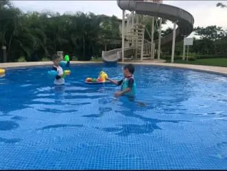 Large outdoor pool and children’s water slide at Buenaventura Resort condo vacation rental Panama