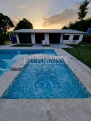Open concept living and dining area overlooking pool in Coronado beach home