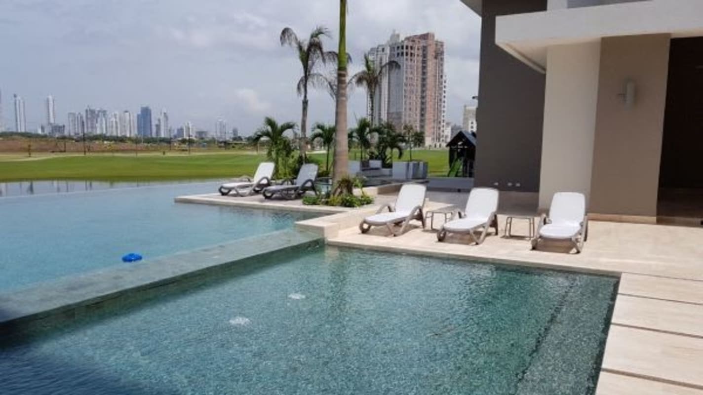 Golf course with palm trees and modern towers Santa Maria Panama The Reserve luxury condos