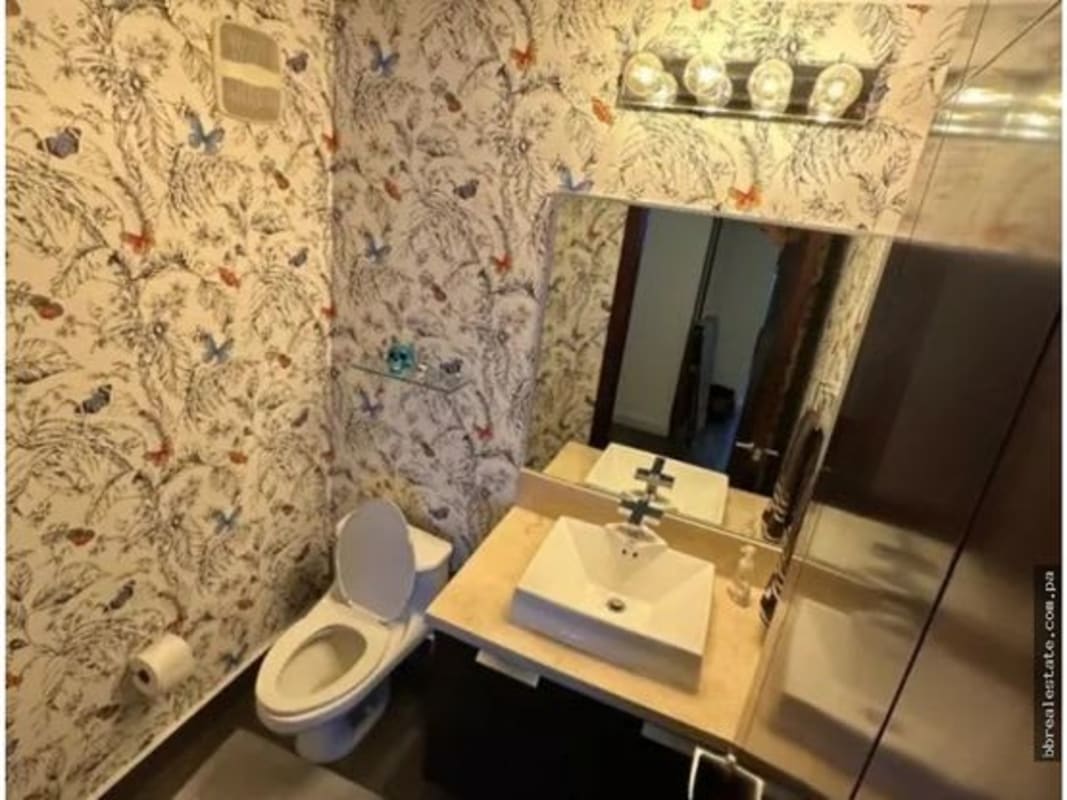 Stylish bathroom with vessel sink, mirror, and designer wallpaper PH Oceanaire Punta Pacifica