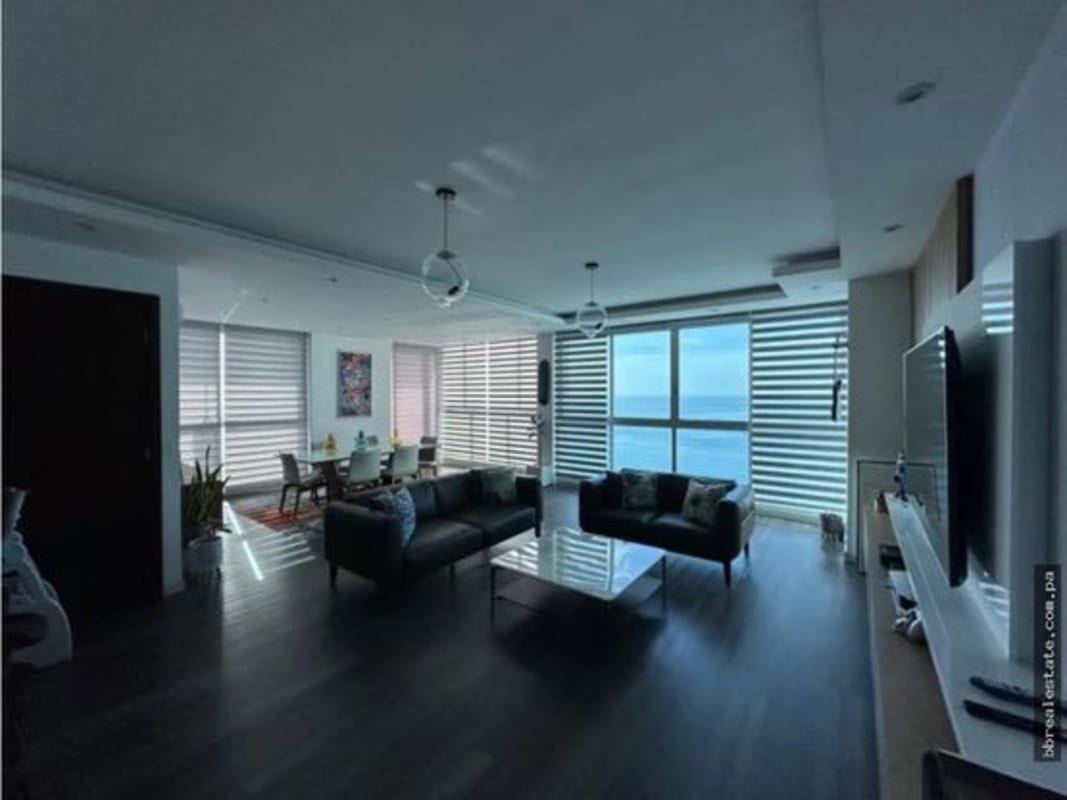 Modern living room with ocean view windows at luxury condo PH Oceanaire for sale in Punta Pacifica Panama