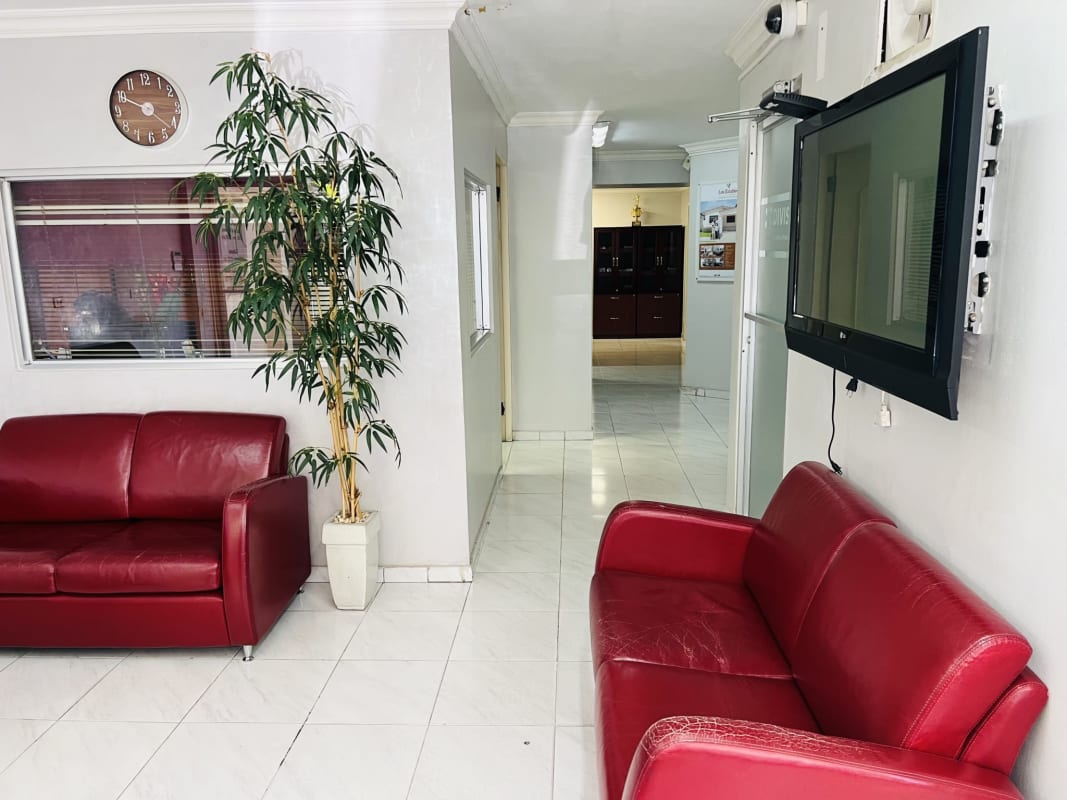 Lobby area with red sofas, flat screen TV in Parque Lefevre commercial building Panama